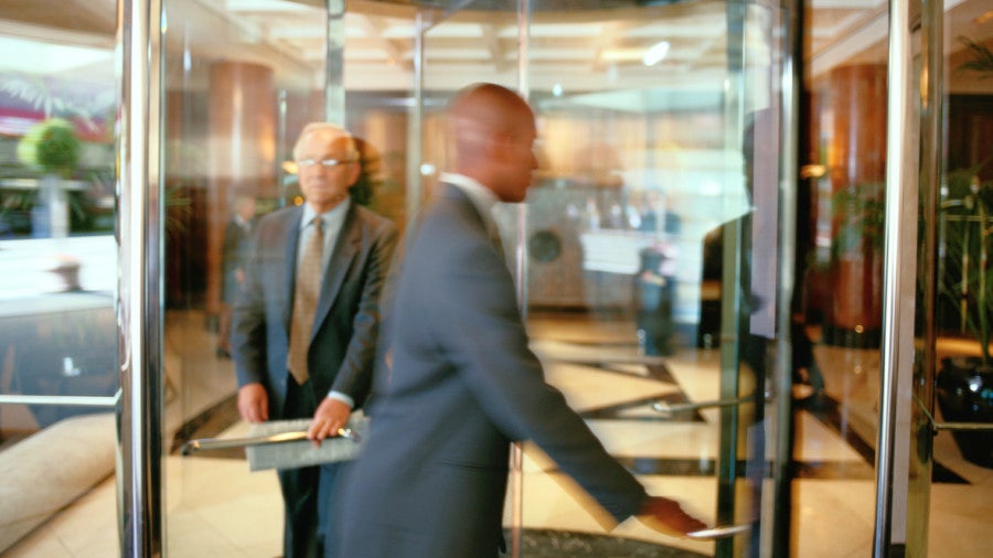 Senior exiting a revolving door