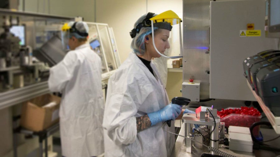 Two employees in an engineering clean room