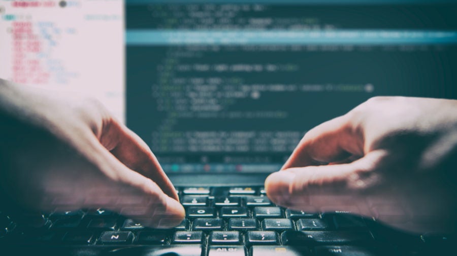 Hands on keyboard typing code, hacker,