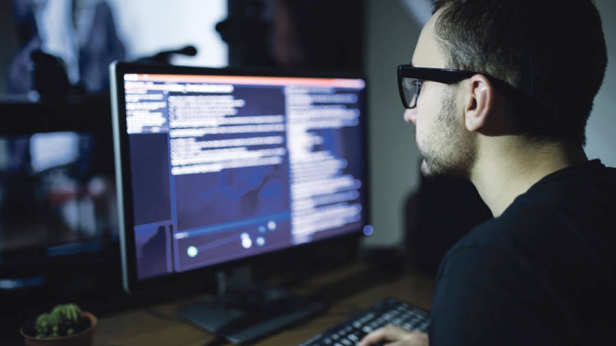 man looking at screen with code on it