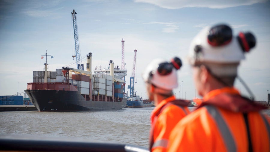 two men in hard hats by Port of hull,