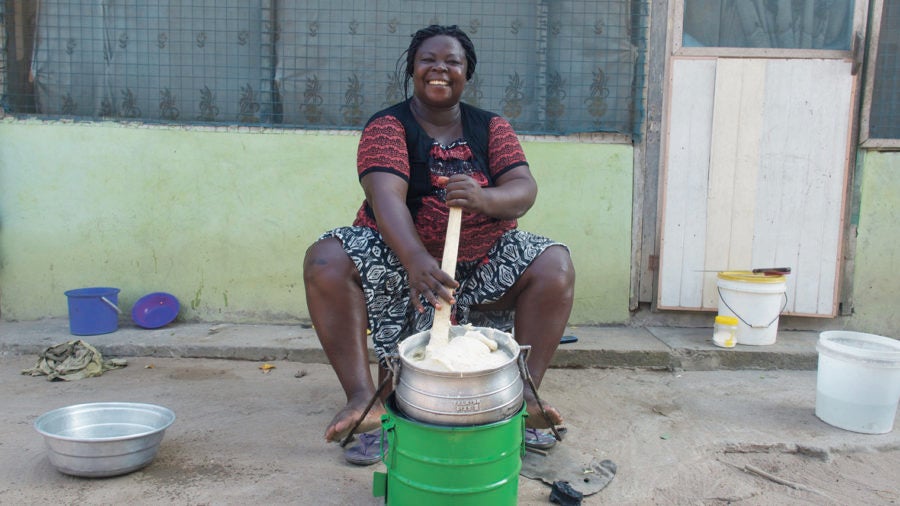 impact investing scheme woman at eco-friendly stove