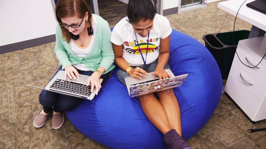 Women on beanbags with laptops diversity in tech