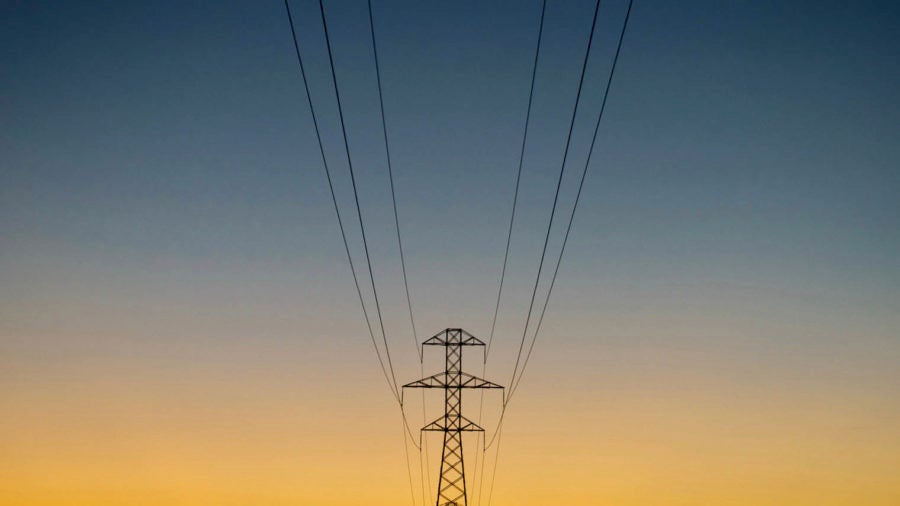 Electricity tower silhoutted against sky