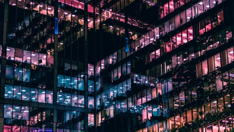 office building at night with purple and blue windows