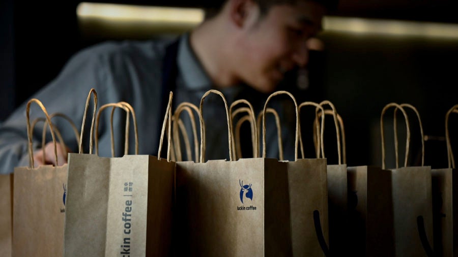 Employee behind Luckin Coffee paper bags