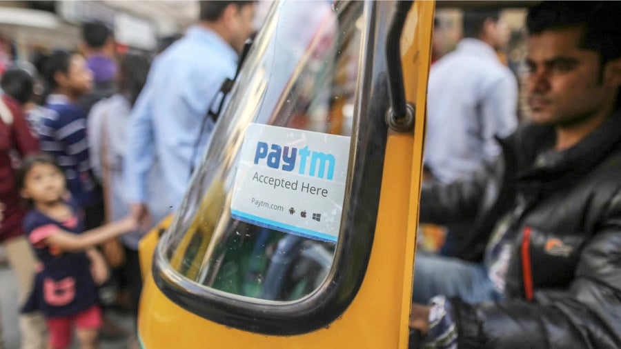 sign for PayTM mobile payments system in window of Indian rickshaw