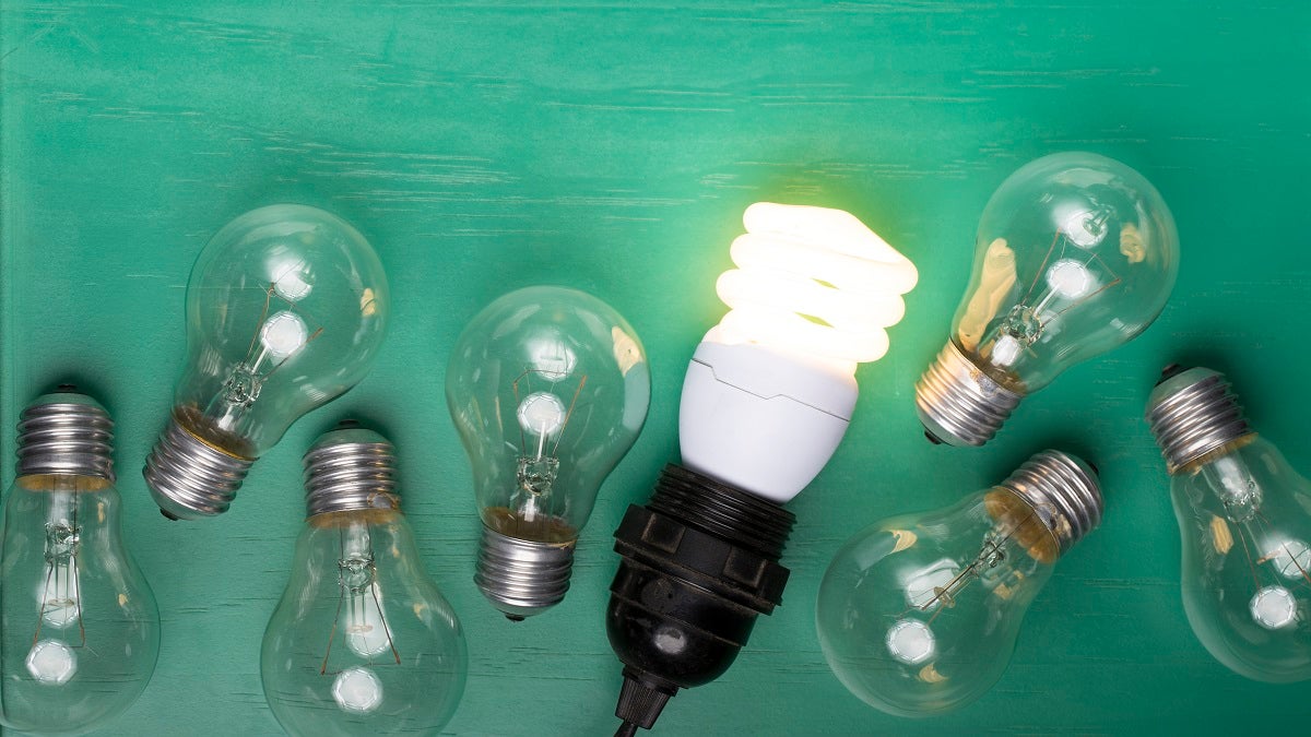 Filament lightbulbs next to one LED lightbulb