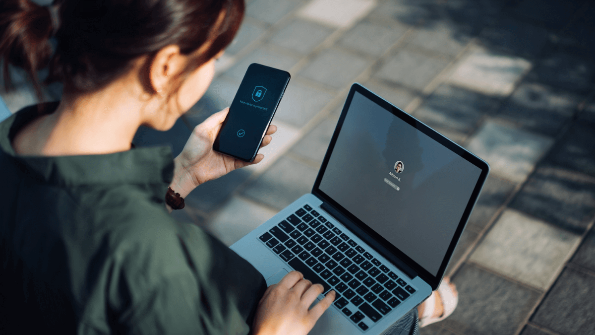 Woman logging into laptop through two-factor authentication