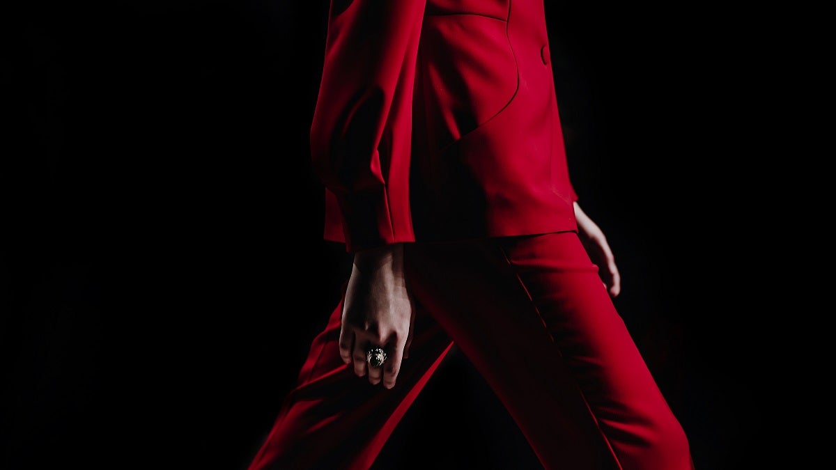 Close-Up Details Of Clothing On A Woman Model In Red Suit Walks On The Fashion Show