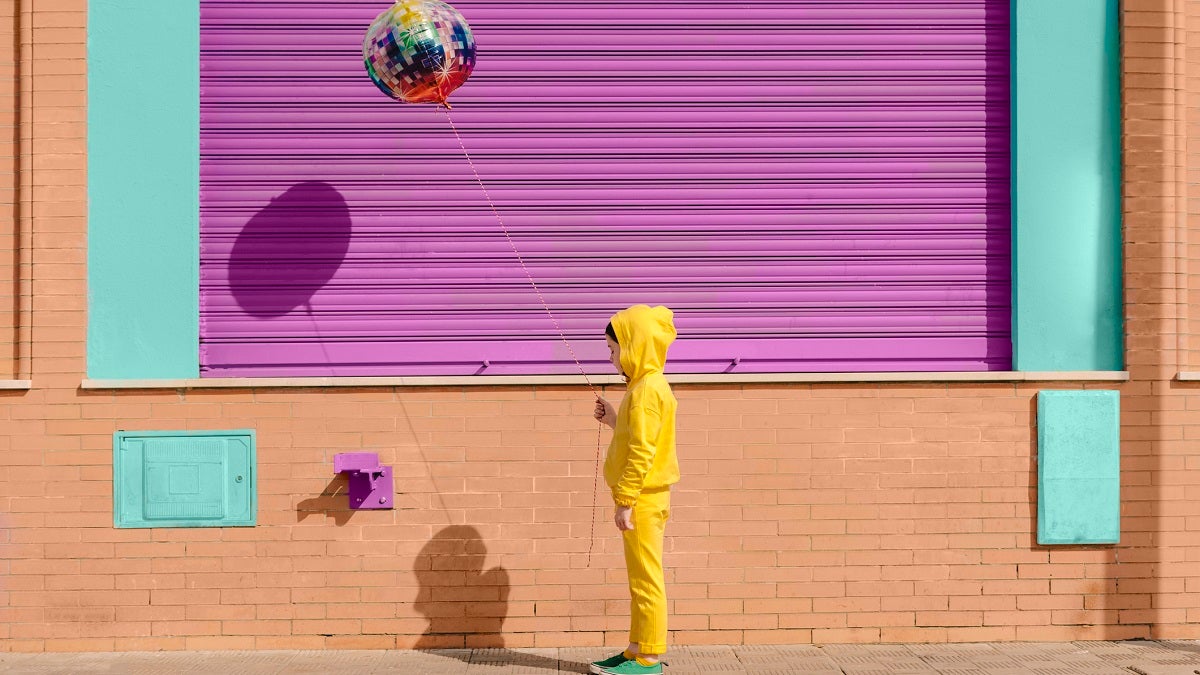 Little girl dressed in yellow with balloon