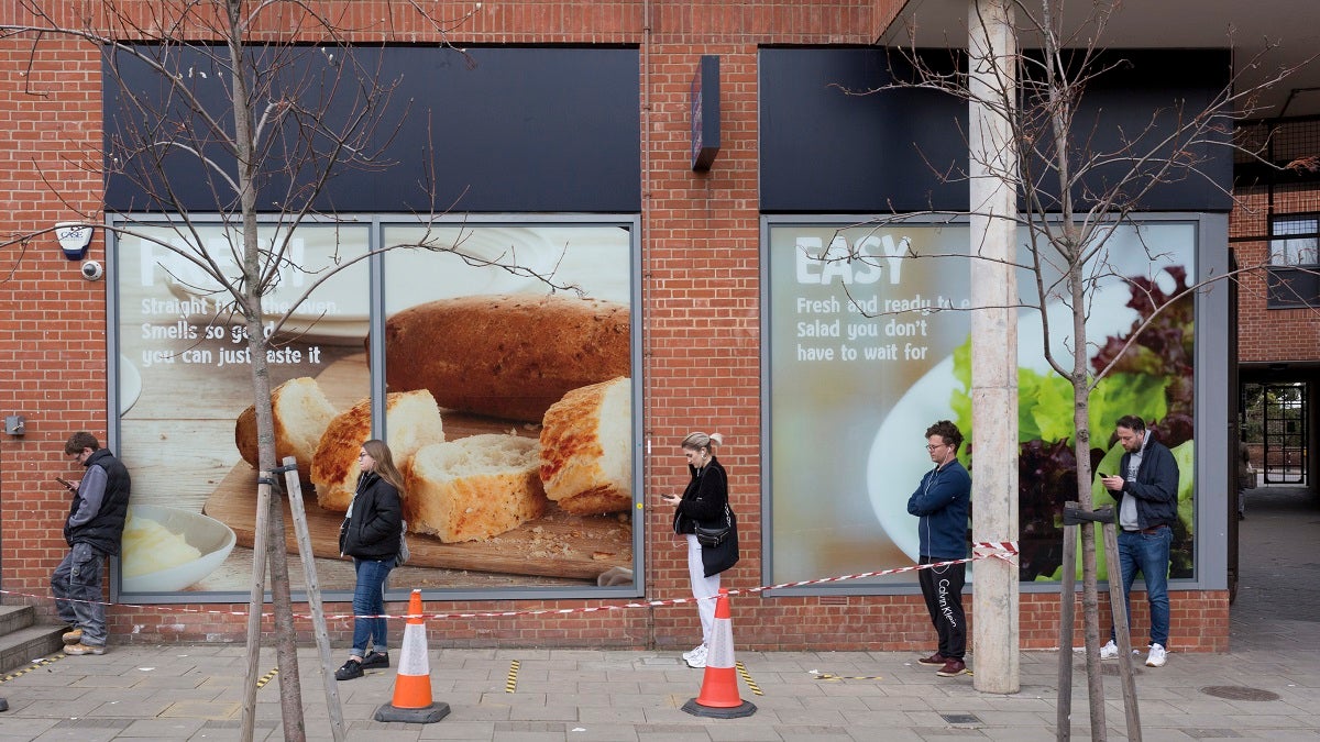 As the second week of the Coronavirus lockdown continues around the capital, and the UK death toll rising by 563 to 2,325, with 800,000 reported cases of Covid-19 worldwide, in accordance with the government's advice for social distancing and non-essential lockdown, shoppers patiently queue outside a local Tesco Express supermarket in Herne Hill, on 1st April 2020, in London, England. (Photo by Richard Baker / In Pictures via Getty Images)