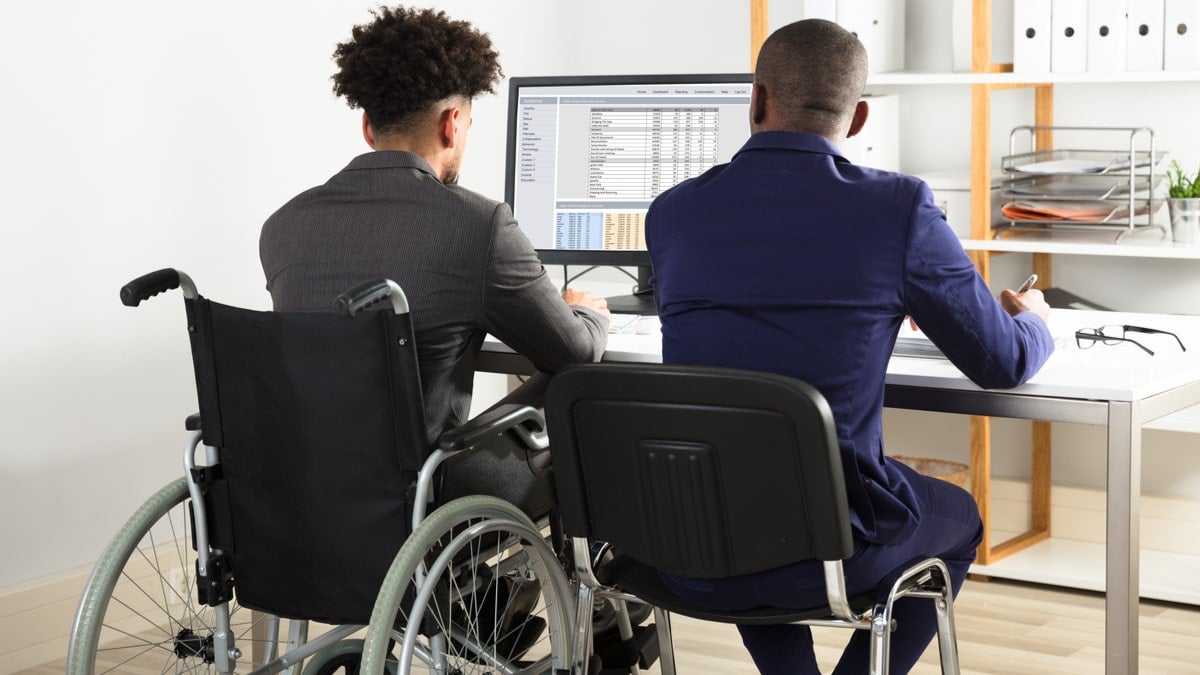 Wheelchair user working at desk