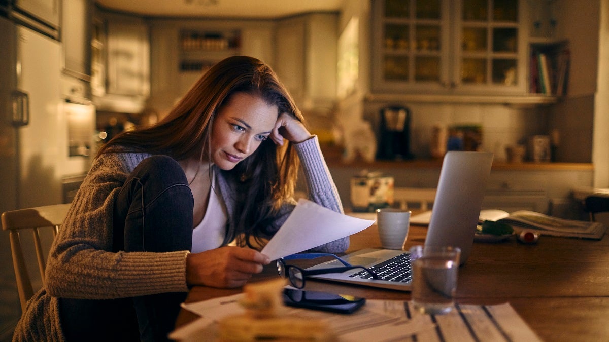 woman looking worried with bills