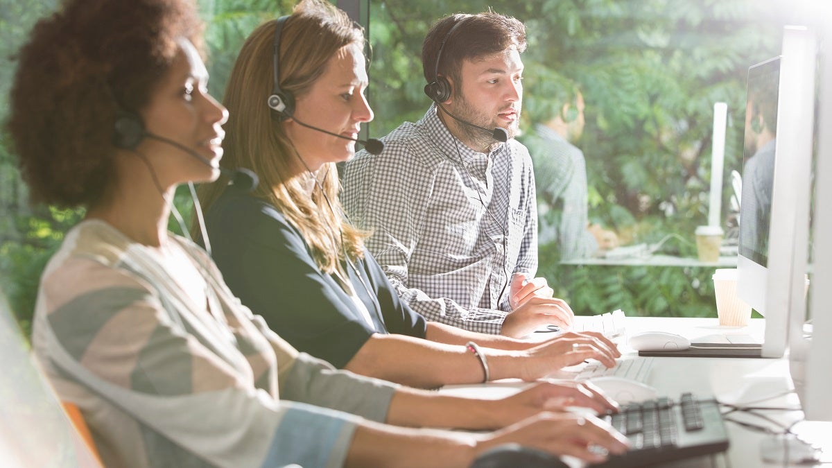 Business people wearing headsets in office