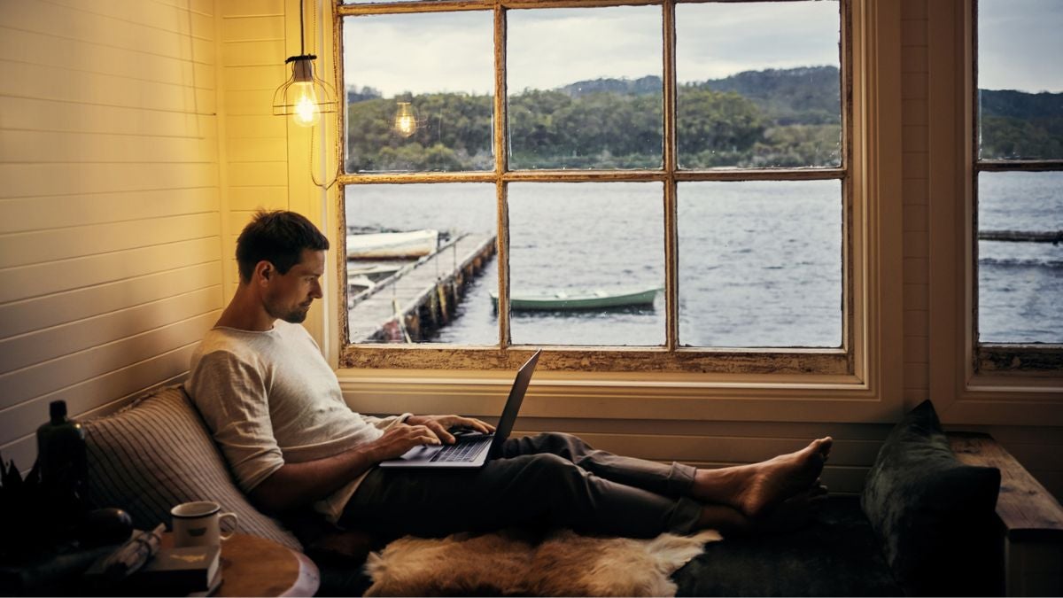 Worker sitting relaxed with his laptop, clearly enjoying autonomy and engagement