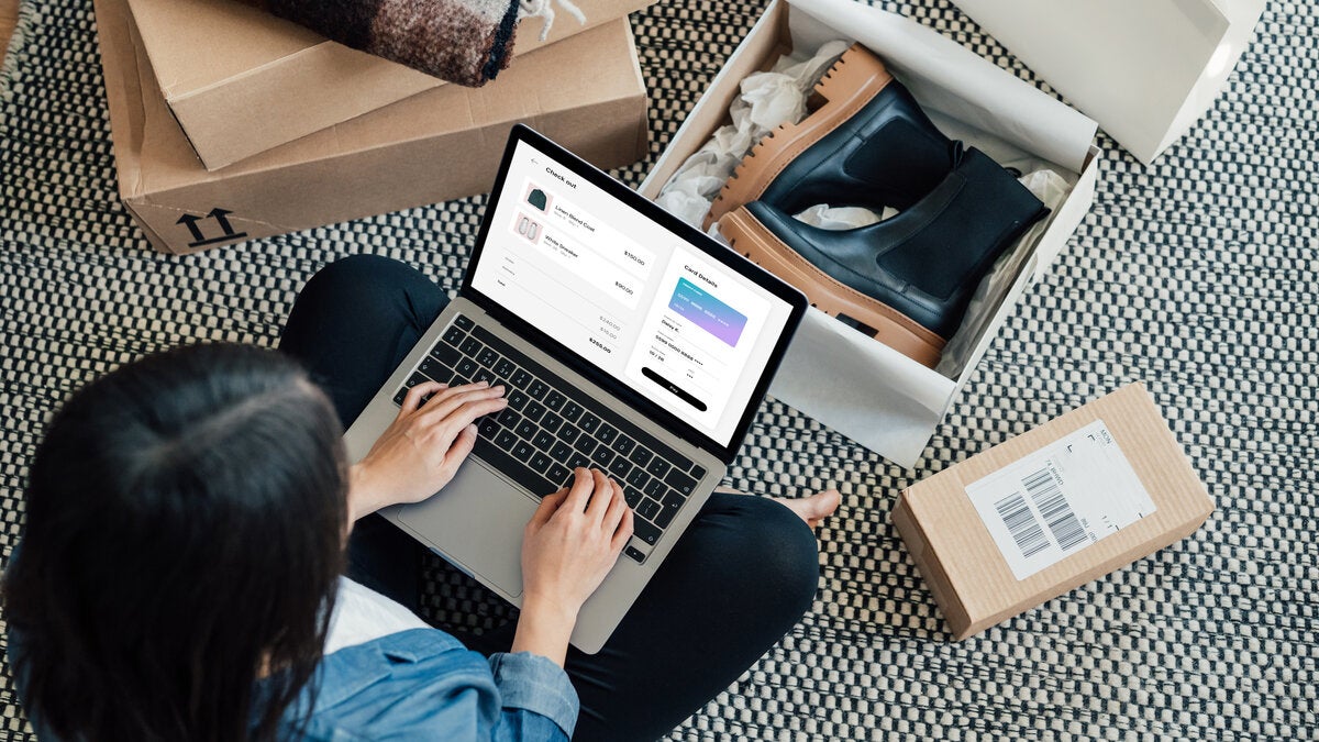 Overhead View Of Young Woman Doing Online Shopping With Laptop