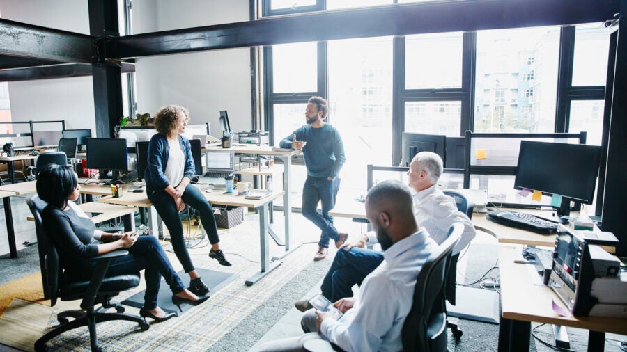 A group of engaged employees having a discussion in a modern office