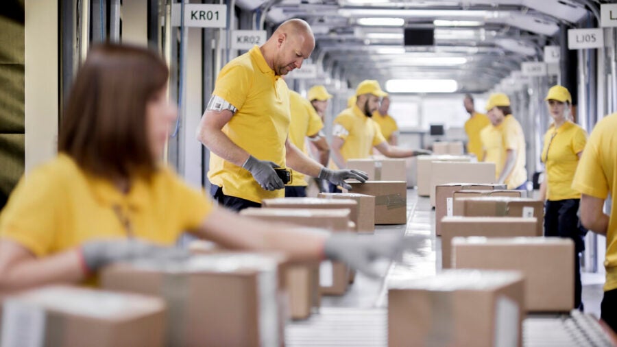 Workers in a warehouse working with cardboard boxes