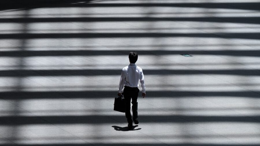Entrepreneur's Mindset Man in suit walking into the light
