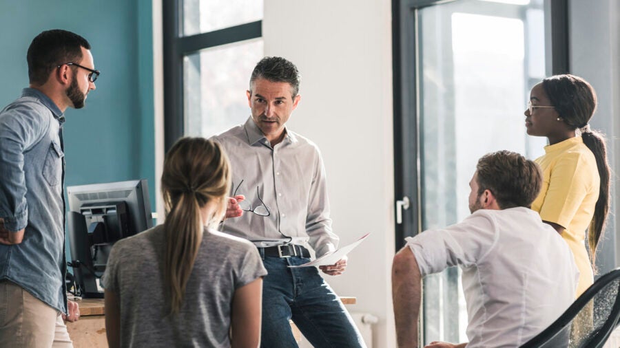 An executive addressing a small informal group of employees