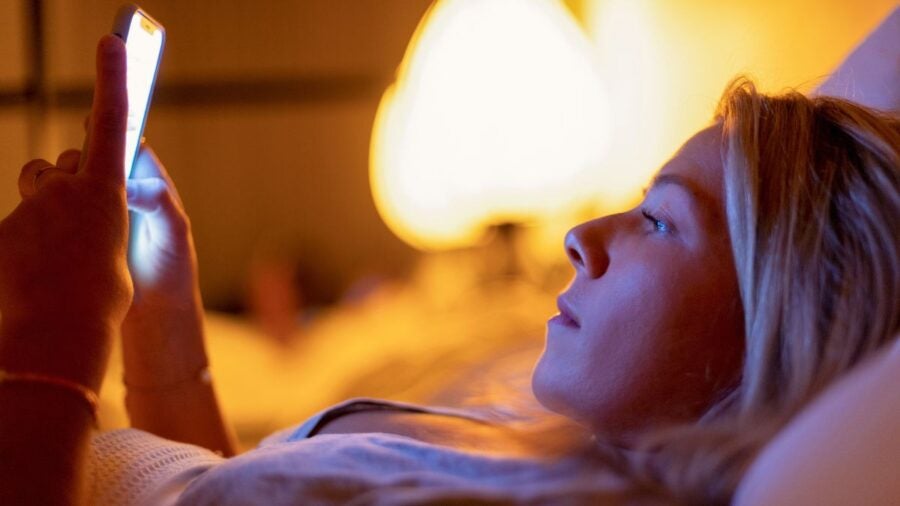 Employee Checks Work Phone While In Bed