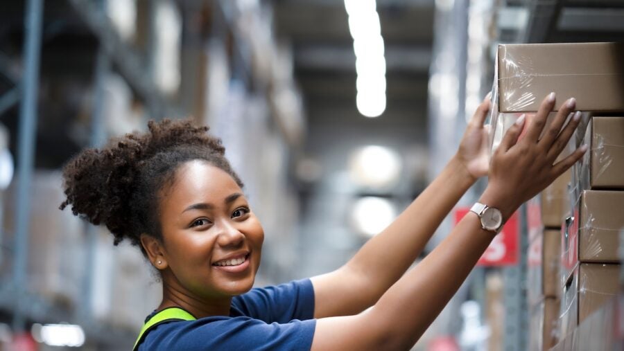 African,american,warehouse,worker,take,flat,box,from,shelf,in