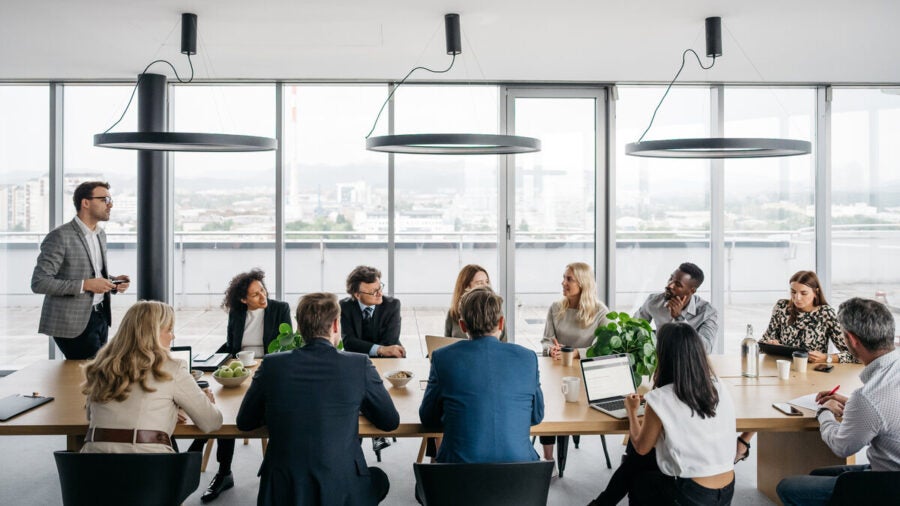 Full table shot of a collaborative business meeting