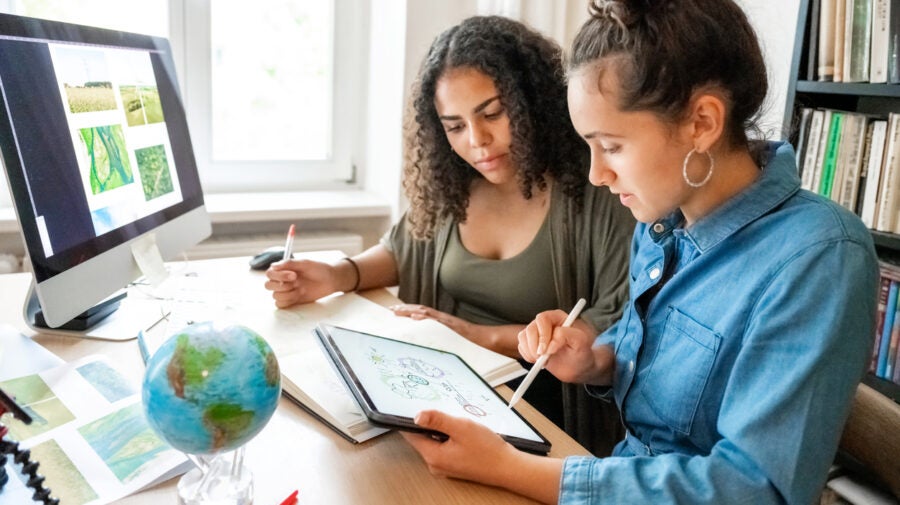 Two Young Woman Working Together On Concepts For Climate Protection