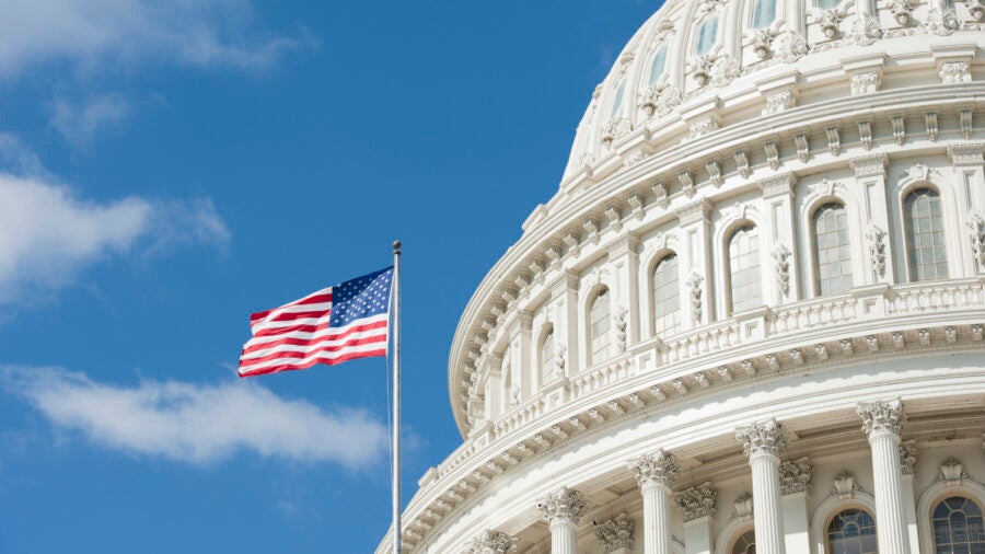 American Flag Waving In Front Of Capitol Hill